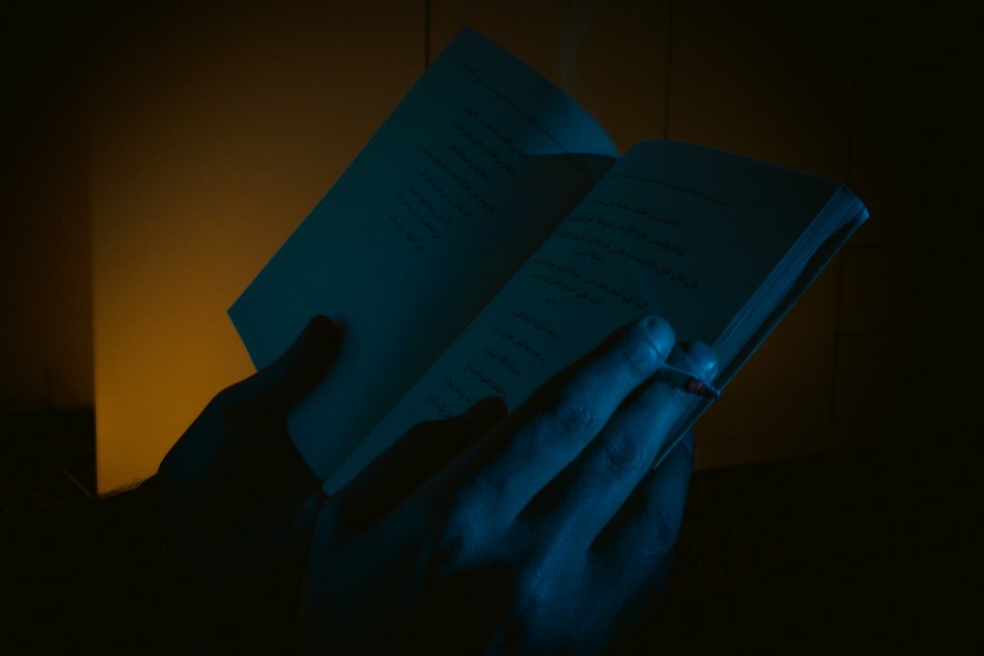 person reading mystery book at night